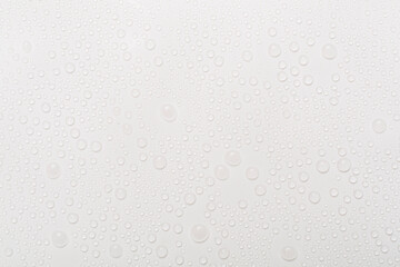 Water drops on color background, top view