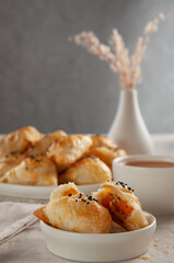 Puff hot samsa with pumpkin and hot tea. Table setting in European style.