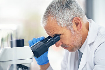 Microscope, science and face of man in laboratory for research, medical analysis and biotechnology....