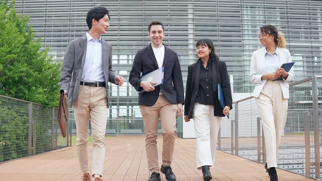 Multinational business group walking in office.