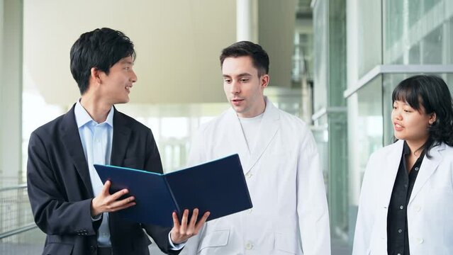 Group of multinational engineers and business people meeting in a building. Medical Representative