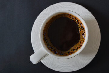 Atmospheric coffee break. Top view of the white cup of coffee. Morning tradition