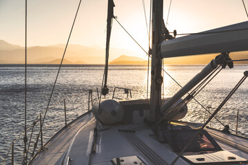 Fototapeta na wymiar Yacht sailing at dawn