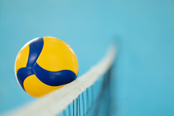 Blurred photo in action of a volleyball near the net. Playing volleyball, ball reaching opponents side of the net © Vitalii