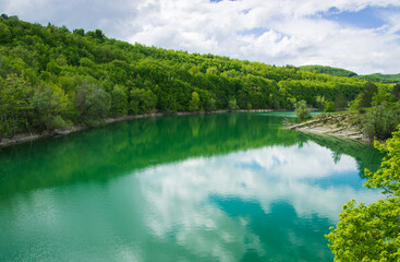 View of the reflection of the clouds on mountain lake in the Marche region Italy