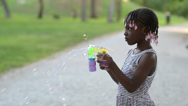 African American girl blowing bubbles