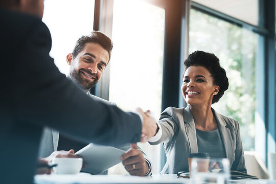 Business people, handshake and meeting for partnership, teamwork or collaboration in boardroom at office. Happy woman shaking hands in team recruiting, introduction or b2b agreement at the workplace