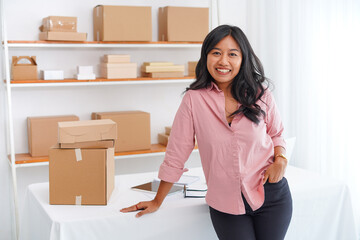 Photo of business asian woman smiling. Lady with pink clothes stands  office desk