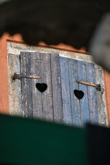 Heart-shaped detail of wooden window covers