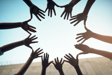 Teamwork, circle and blue sky with hands of people for support, community and help with bottom view. Collaboration, trust and motivation with closeup of friends for partnership, solidarity and faith - obrazy, fototapety, plakaty