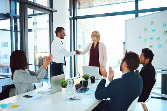 Congratulations, handshake and professional with support at a meeting for teamwork and collaboration at a company. Business people, applause and presentation with success for agreement in office.