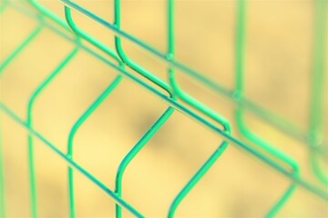 New green grid fence close up. Perspective view. Selective focus