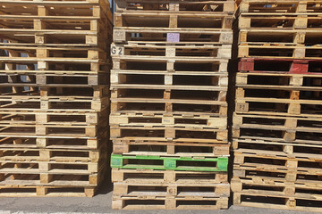 Many pallets stacked in stock, warehouse pallets, blue wooden pallets