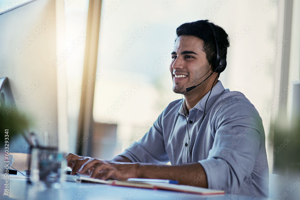 Poster Customer support agent, smile and man in office consulting with advice, crm and happiness at work. Happy phone call, conversation and telecom help desk consultant speaking into headset at computer.