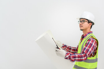 Asian handsome young man architect engineer looking at construction blueprints Engineering and architecture concept isolated on white background. Copy Space Posing Over White Studio Background