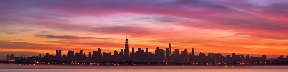 Fototapeta premium extreme wide angle of a multi colored sky and skyline at dawn in soft, muted pastel colors pink and blue