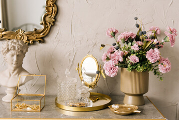 Details of the luxurious interior of a women's dressing table with flowers and decorations