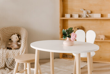 Stylish Scandinavian-style children's room interior with handmade wooden products