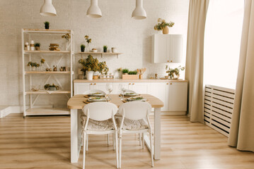 Kitchen white wooden kitchen with Scandinavian-style dining area decorated with mimosa