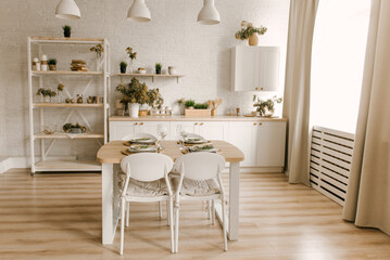 Kitchen white wooden kitchen with Scandinavian-style dining area decorated with mimosa