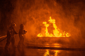 silhouette of a Fireman dousing flames