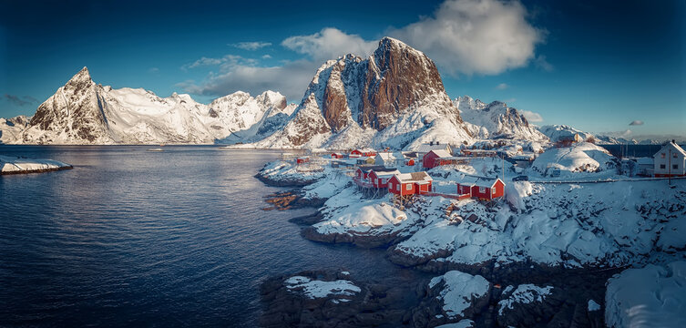 Hamnoy fishing village on Lofoten Islands, Norway with red rorbu houses in winter. Concept of Travel and holiday on nature, tourist and fishing leisure. Iconic location for landscape photographers