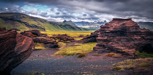 Amazing Iceland nature landscape. Scenic Image of Iceland. red sandy Volcanic rock formation near Dyrholaey coast of Iceland, Europe. Typical Icelandic scenery in sunset
