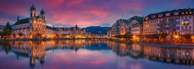 Scenic evening panorama view of the Old Town medieval architecture in Lucerne, Switzerland. Dramatic scene with Reuss river and Jesuit church. Wonderful vivid cityscape during sunset with colorful sky - 603301938