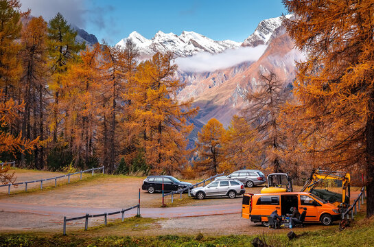 Cars parking under alpine mountain in Switzerland. campsites in the autumn mountains. Travel on car is a Lifestyle, conception. Idea of Adventure lifestyle.