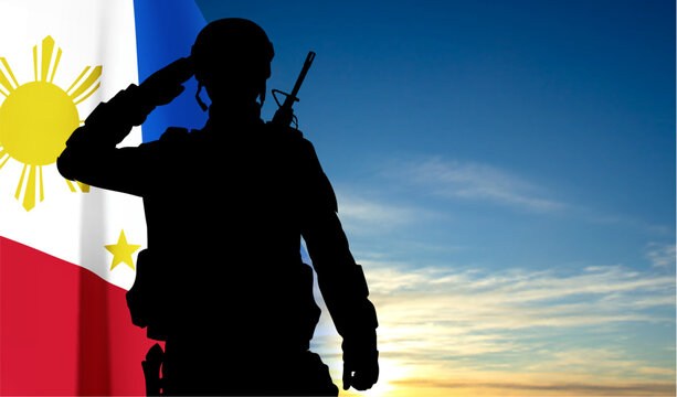 Silhouette of a saluting soldier with Philippines flag on background of sky. Concept - Independence day. EPS10 vector