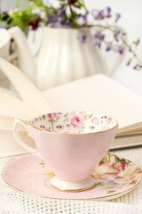 Decorative tea cup with a book