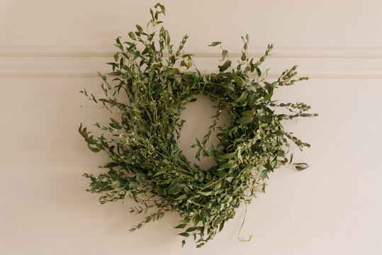 A round spring green wreath adorns the wall