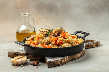 Uzbek pilaf in cast-iron pan. banner, menu, recipe place for text, top view