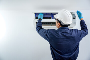 Close-up of a Air conditioner technician, repair service, install air conditioner in the house Are going to repair and take care of filling air conditioners in homes and buildings.
