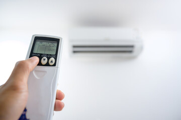 Air conditioner remote control, adjust the temperature to 25 degrees Celsius with a remote control in the room at home.