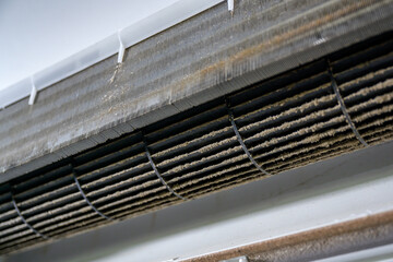 Fototapeta premium Close up of dirty dust on the air conditioner filter. Accumulation of dust requiring replacement of the air filter in the air conditioner For the health safety of the air conditioner in the house