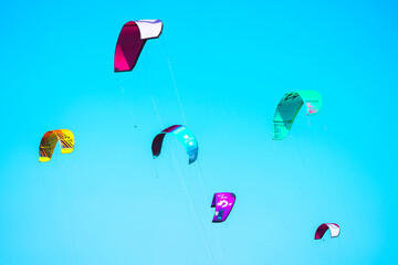 Kites in the sky. Sportsmen and sportswomen practicing kitesurf at the Spanish coasts. Kite surf...
