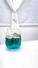 glass of water on blue background