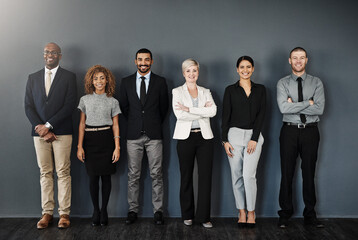 Diversity, smile and portrait of business people in studio for support, community and teamwork. Happy, collaboration and professional with employees and wall background for motivation and mission