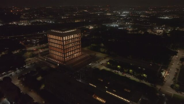 Drone view at night of the Palazzo della Civilt&agrave; Italiana, known as Colosseo Quadrato ("Square Colosseum"), building in the EUR district of Rome, Italy. Example of fascist architecture, aerial view