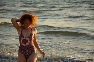 Young woman in swimsuit on a sand beach. summer holiday concept.