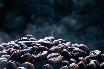 Coffee beans roasting with smoke,  selective focus, and soft focus.