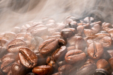 Coffee beans roasting with smoke,  selective focus, and soft focus.