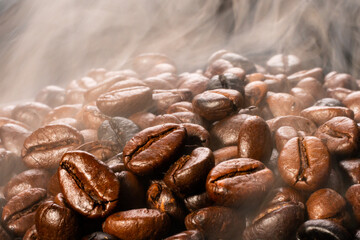 Coffee beans roasting with smoke,  selective focus, and soft focus.