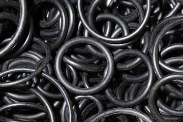 Black hydraulic and pneumatic rubber o-ring seals of different sizes. Spare part gasket