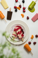 strawberry popsicles and fruit cut ice in flat lay