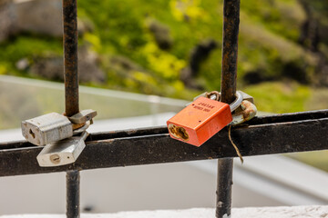 old rusty metal fence with a padlock