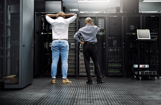 Server room, it support or electrician fixing a problem for hardware maintenance or stressful glitch crisis. Confused or back of worried technicians or electrical engineers in information technology