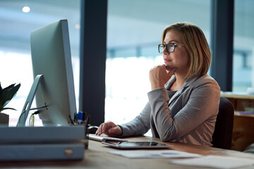 Computer, thinking and business woman in office working late on project at night alone. Desktop,...