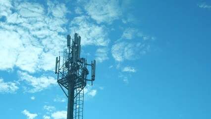 Cell Tower Of Mobile Operators, Cell Station Close-up and Blue Sunny Sky with White Clouds.